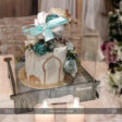A clear acrylic cake box elegantly displaying a beautifully decorated cake, perfect for Eid and Ramadan celebrations. The box features a secure lid and a stylish design, ideal for showcasing treats during festive gatherings.