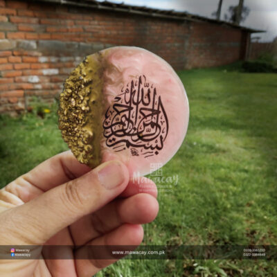 A colorful resin fridge magnet featuring an intricate design, displayed on a refrigerator. The magnet adds a playful touch to the kitchen while holding notes and reminders.